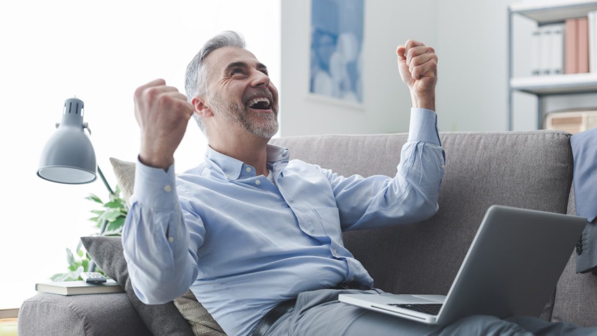 Cheerful businessman with raised fists